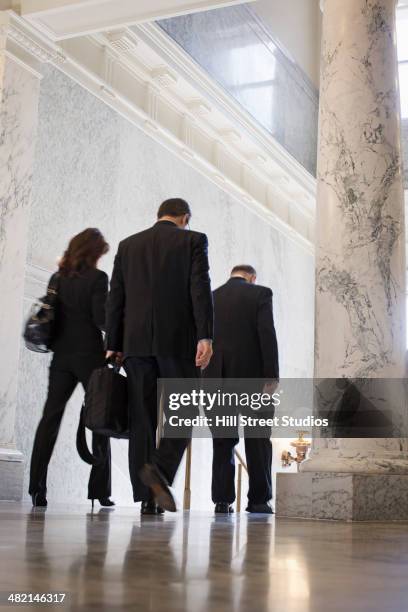 caucasian politicians walking in government building - politician back stock pictures, royalty-free photos & images