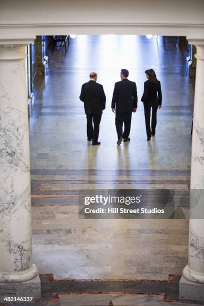 caucasian politicians talking in government building - local government building stockfoto's en -beelden