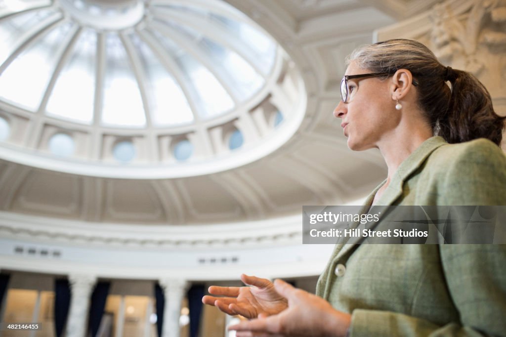 Caucasian politician talking in government building