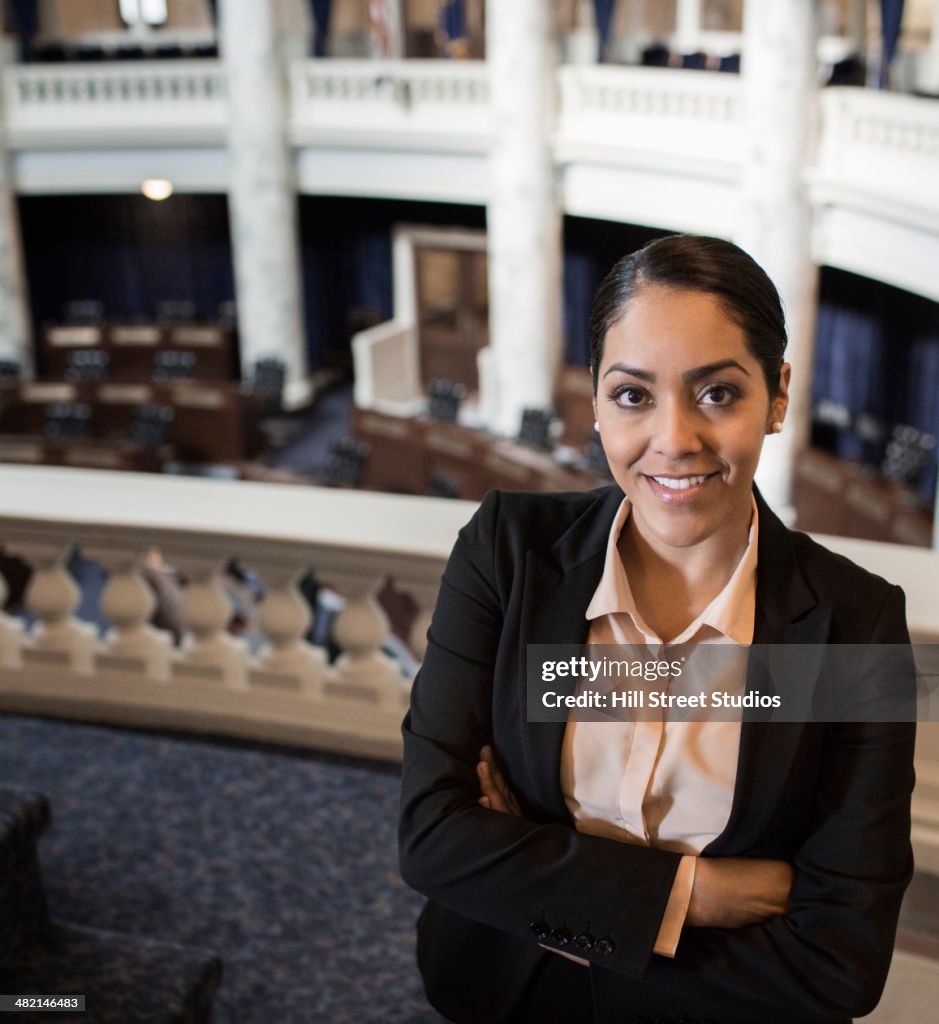 Hispanic politician smiling in chamber