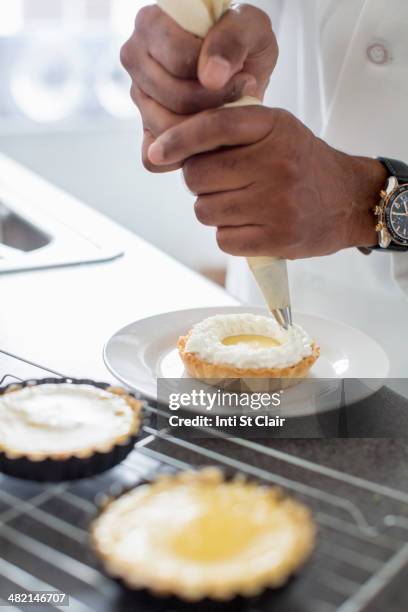 black chef making key lime tart in restaurant - cream tube stock pictures, royalty-free photos & images