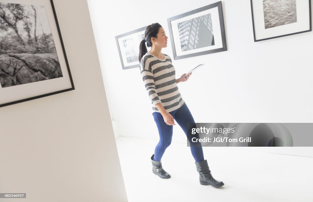 Korean woman admiring art in gallery