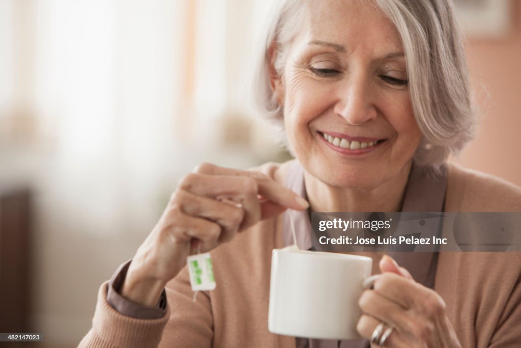 Senior Caucasian woman having cup of tea