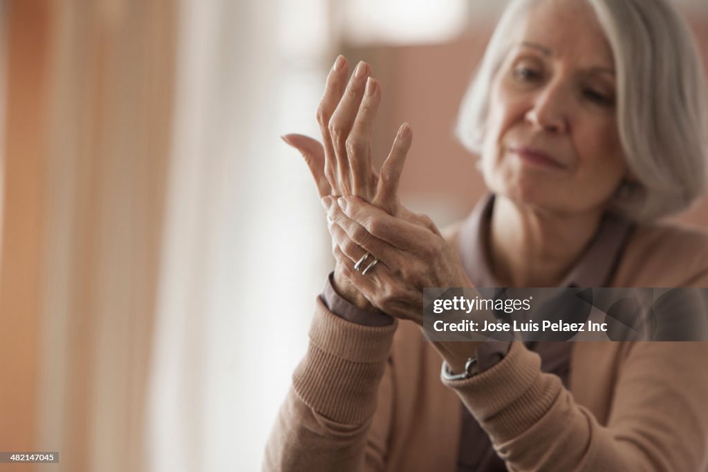 Senior Caucasian woman rubbing her hands