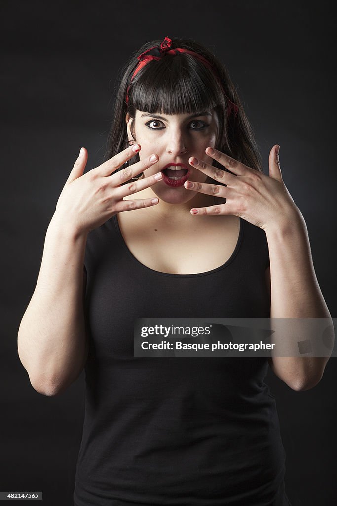 Pin-up woman surprised face teaching hands