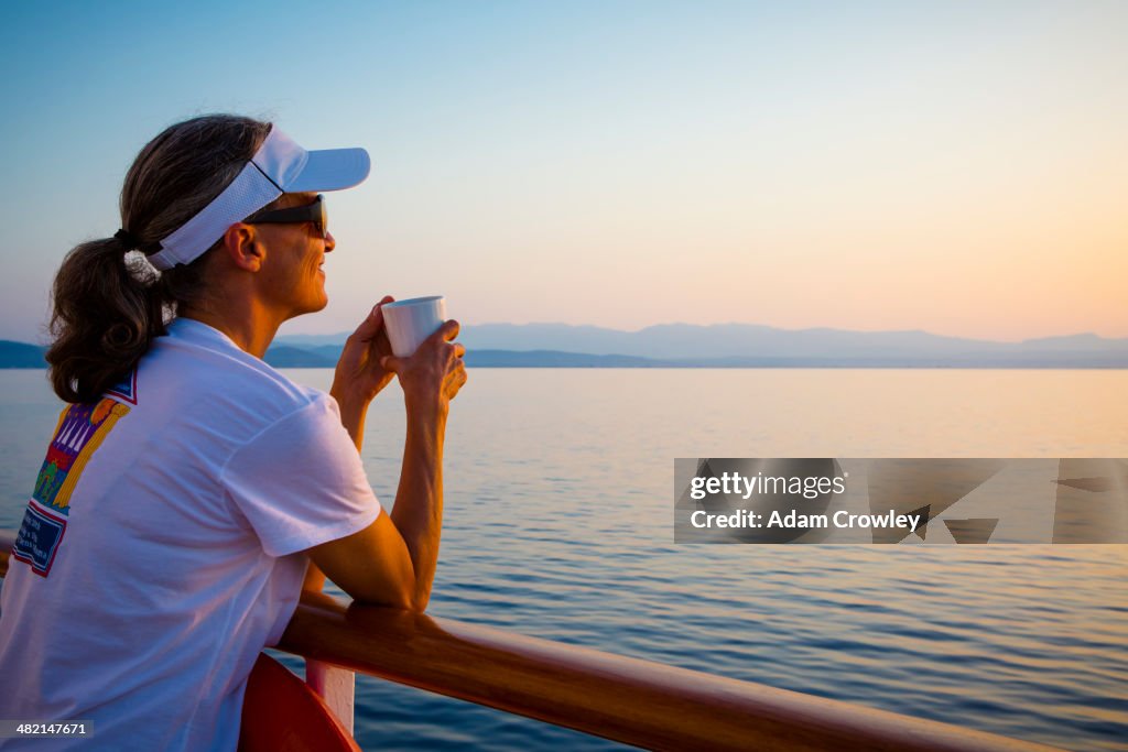 Caucasian woman overlooking ocean from boat deck