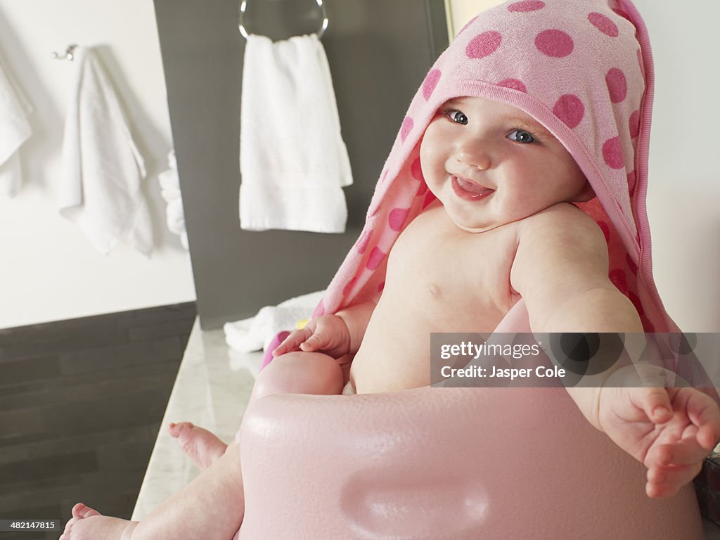 Caucasian baby girl siting in high chair
