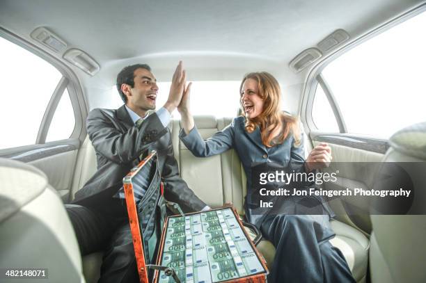 business people high fiving in backseat of car - human mouth stock photos et images de collection