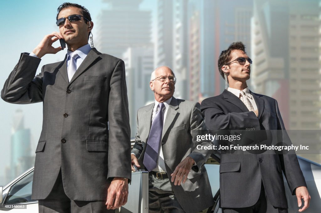 Bodyguards protecting businessman on city street