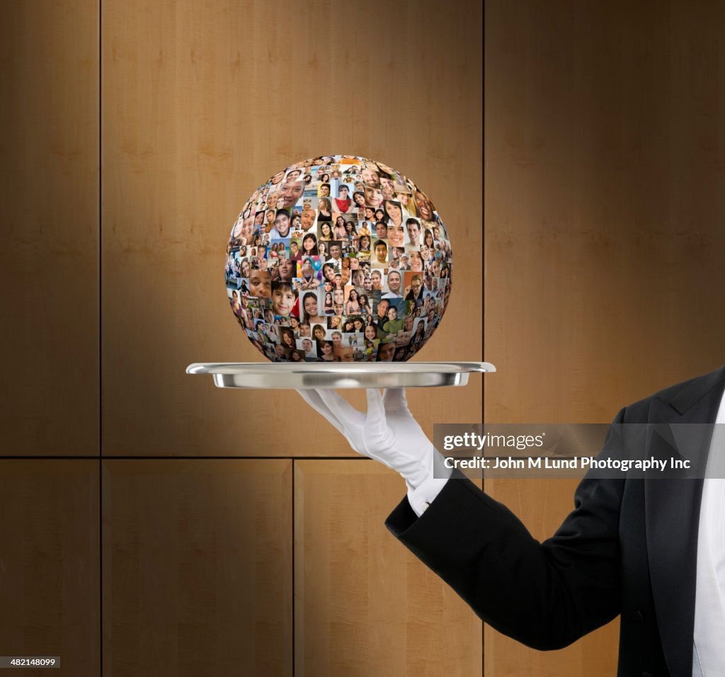 Waiter holding globe collage of business people's faces