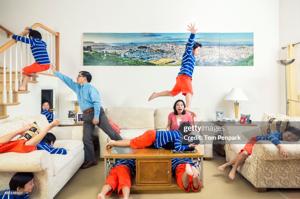 Chinese parents watching son climb all over house