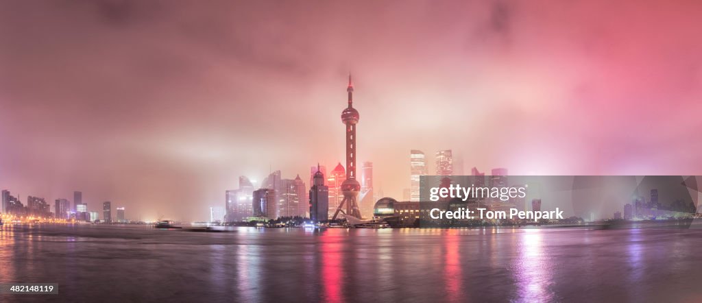 City skyline lit up at night, Shanghai, China