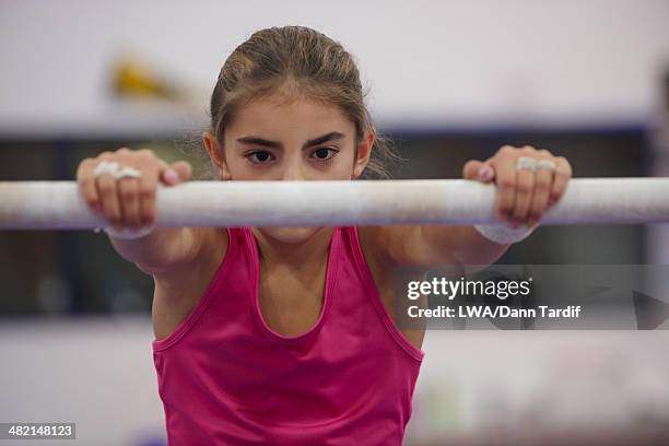 caucasian gymnast practicing on bar - gymnastics bar stock pictures, royalty-free photos & images