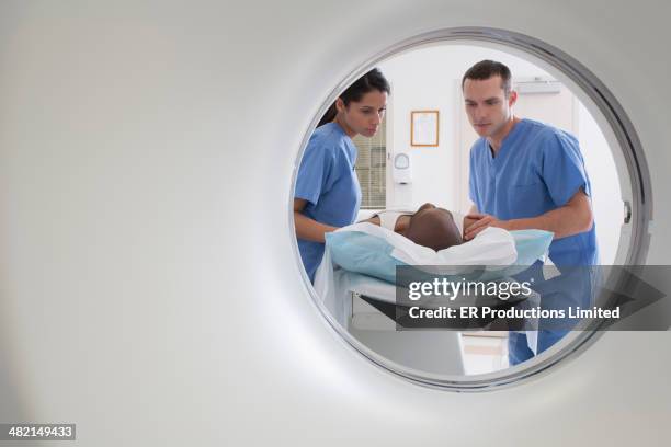 nurses talking to patient before cat scan - ct scanner stockfoto's en -beelden