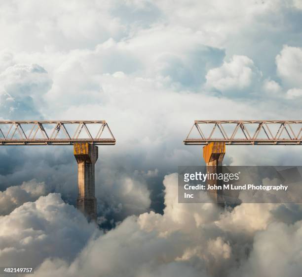 clouds surrounding gap in bridge - reconciliation stock-fotos und bilder