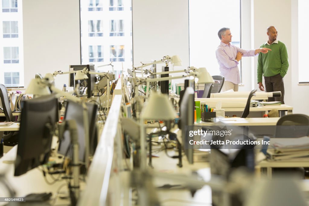 Businessmen talking in office