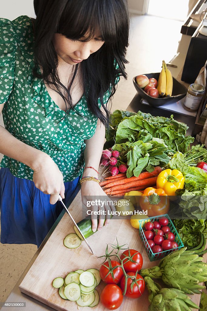 Woman chopping vegetables in kitchen