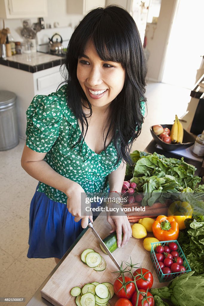 Woman chopping vegetables in kitchen