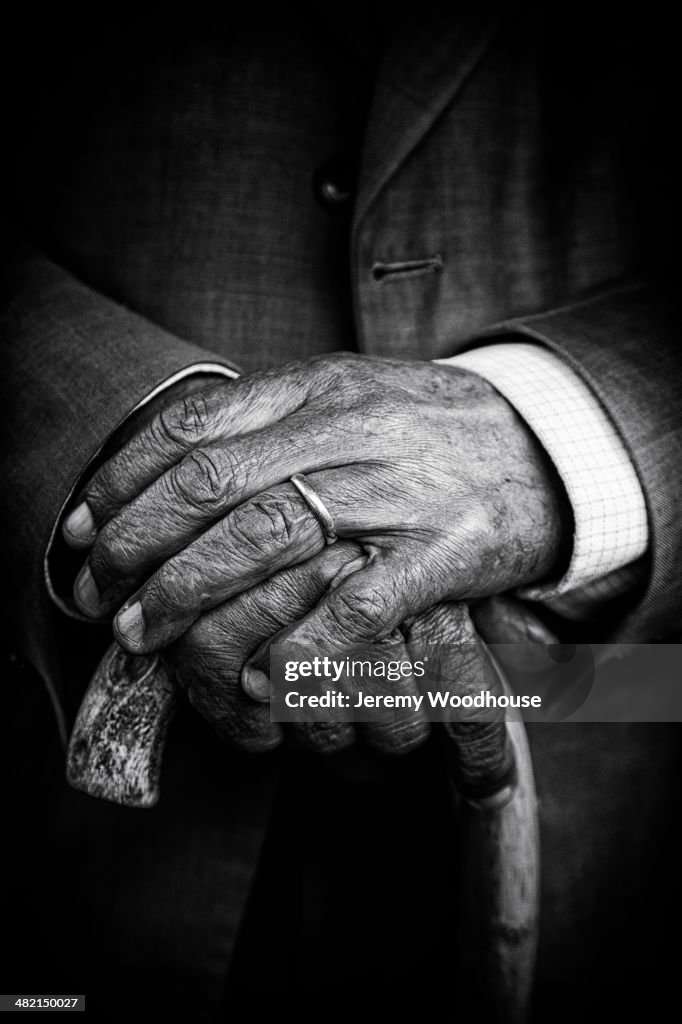 Close up of senior man's hands on cane