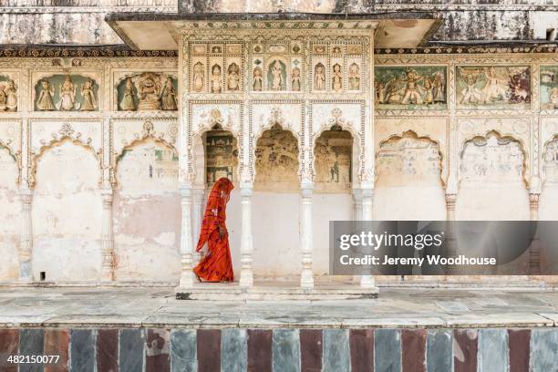 woman in sari walking through cloister, pushkar, rajasthan, india - rajasthani women stock pictures, royalty-free photos & images