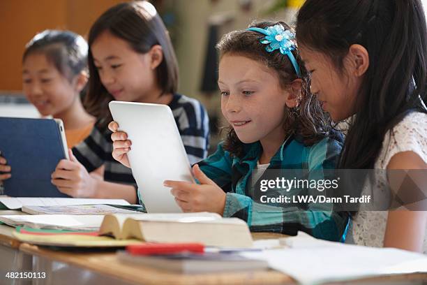 students using digital tablets in class - tablet school stock-fotos und bilder