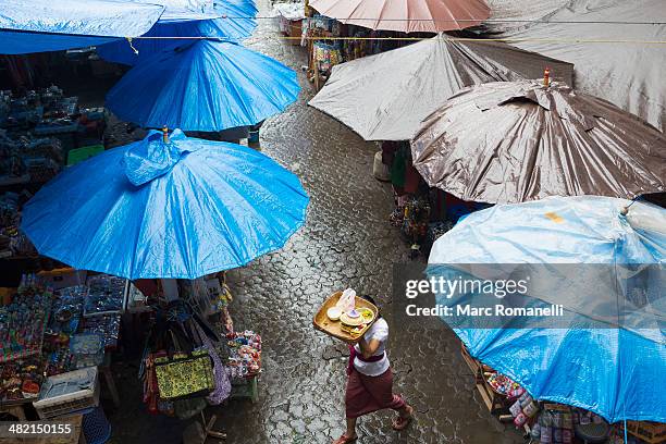 rain falling over tarps and awnings of market stalls, ubud, bali, indonesia - awning stock pictures, royalty-free photos & images