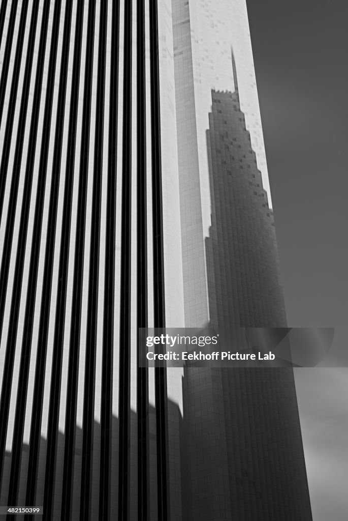 Skyscraper casting shadow on office building