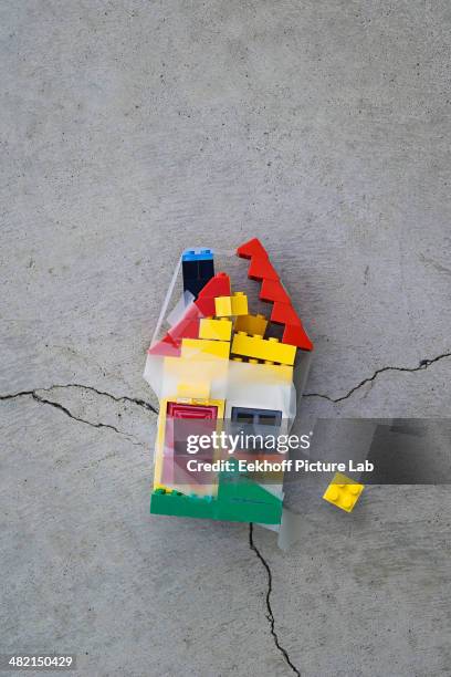 plastic block house taped together on concrete - broken stock pictures, royalty-free photos & images