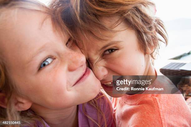 children playing outdoors - siblings stock-fotos und bilder