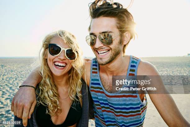 couple smiling together on beach - venice couple foto e immagini stock