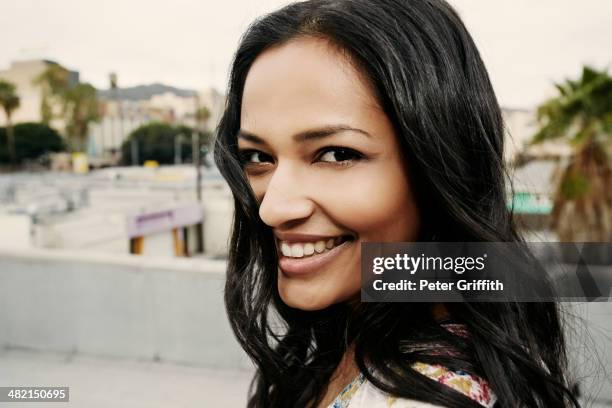 indian woman smiling on urban rooftop - una sola mujer joven fotografías e imágenes de stock