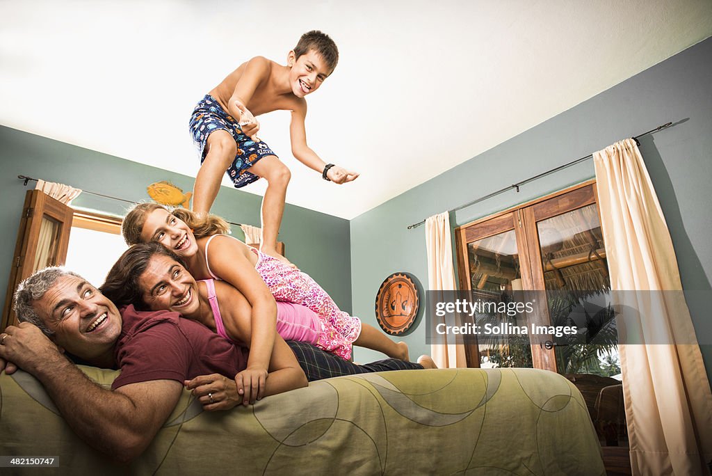 Family playing together on bed