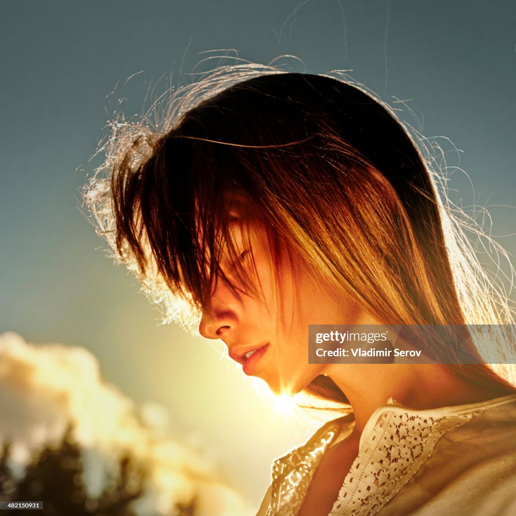 Caucasian girl standing in sun outdoors