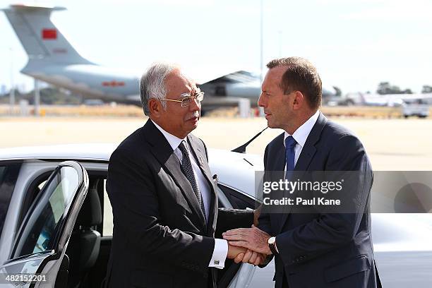 Australian Prime Minister Tony Abbott bids farewell to Malaysian Prime Minister Najib Razak after his visit to Perth during the search of missing...