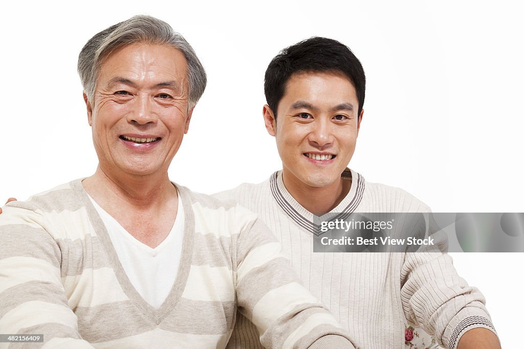 Studio shot young man and his father