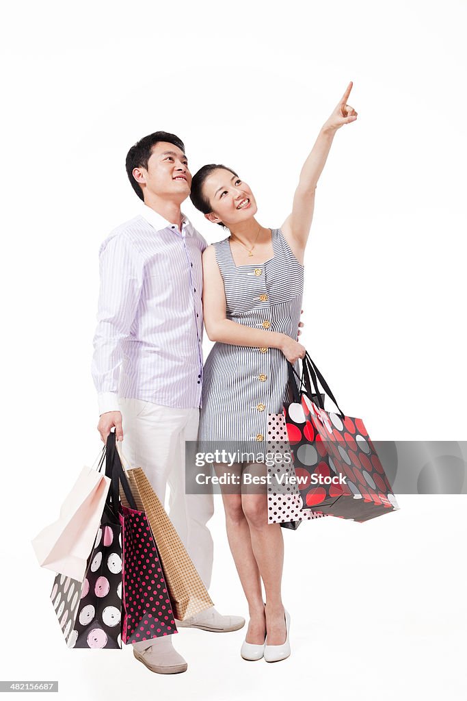 Studio shot young couple shopping