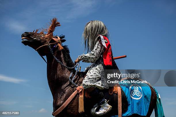 Samurai horseman waits to take part in the Kacchu-keiba during the Soma Nomaoi festival at Hibarigahara field on July 26, 2015 in Minamisoma, Japan....