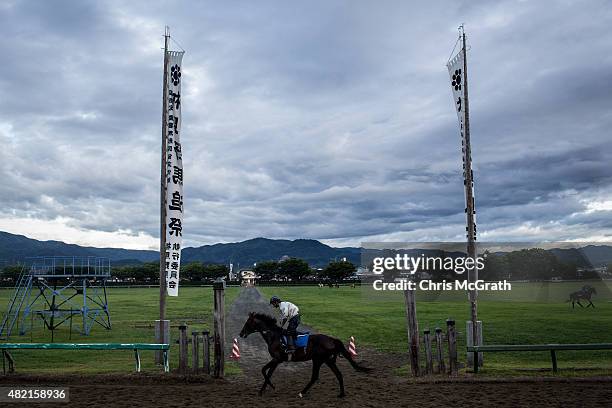 Horseman trains for the Kacchu-keiba ahead of the Soma Nomaoi festival at Hibarigahara field on July 24, 2015 in Minamisoma, Japan. Every summer the...