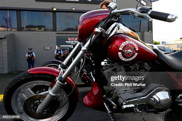 Armed police stand guard as seized motorcycles are removed from a boxing gym run by the Head Hunters gang on Marua Road in Ellerslie on July 28, 2015...