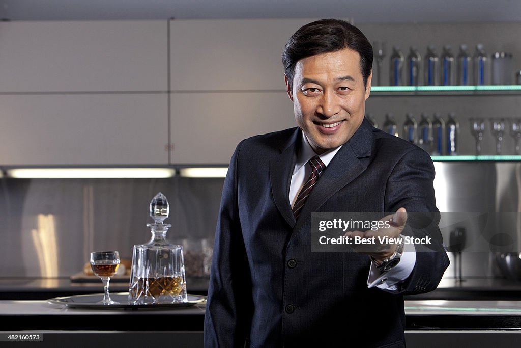 Office man drinking wine beside the bar