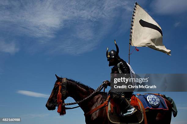 Samurai horseman waits to take part in the Kacchu-keiba during the Soma Nomaoi festival at Hibarigahara field on July 26, 2015 in Minamisoma, Japan....