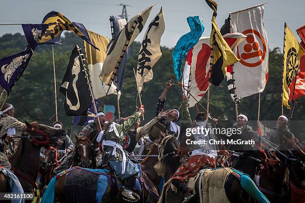 Samurai horsemen jostle for position as they try to catch a flag during the Shinki-soudatsusen at the Soma Nomaoi festival at Hibarigahara field on...