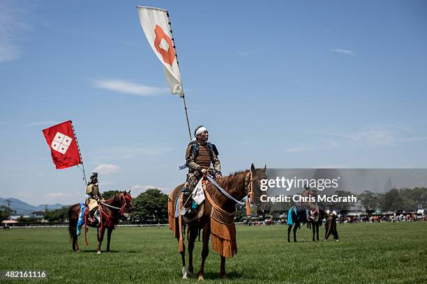 Samurai horsemen wait to to compete during the Soma Nomaoi festival at Hibarigahara field on July 26, 2015 in Minamisoma, Japan. Every summer the...