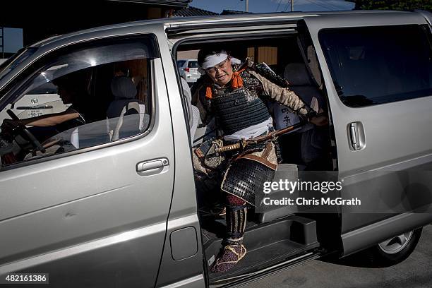 Kazuhzko Suzuki, 53 a member of the Uda Clan climbs into a van as he heads off to participate in his first Soma Nomaoi festival on July 26, 2015 in...