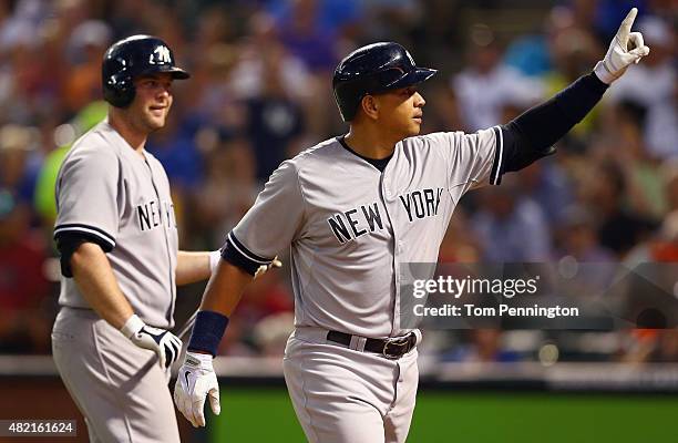 Alex Rodriguez of the New York Yankees celebrates with Brian McCann of the New York Yankees after hitting a solo home run against the Texas Rangers...