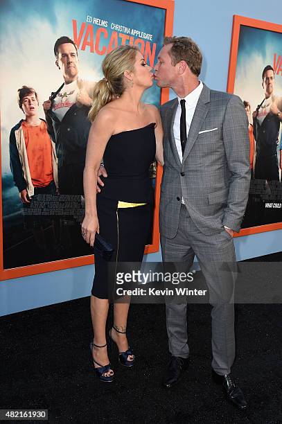 Actress Christina Applegate and musician Martyn LeNoble attend the premiere of Warner Bros. Pictures "Vacation" at Regency Village Theatre on July...