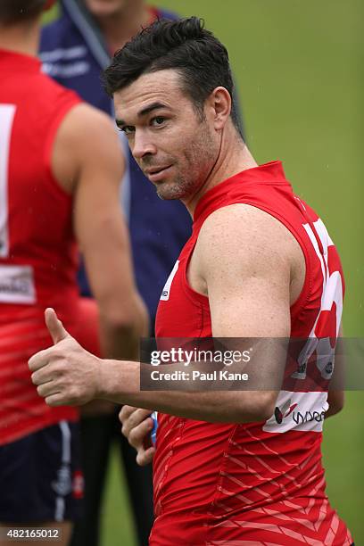 Ryan Crowley gives the thumbs up to supporters after walking onto the oval during a Fremantle Dockers AFL training session at Fremantle Oval on July...