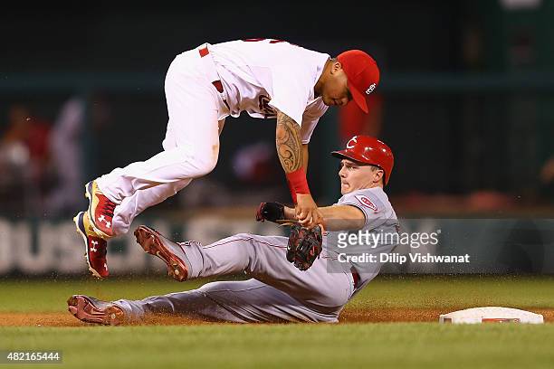 Jay Bruce of the Cincinnati Reds breaks up double play against Kolten Wong of the St. Louis Cardinals in the sixth inning at Busch Stadium on July...