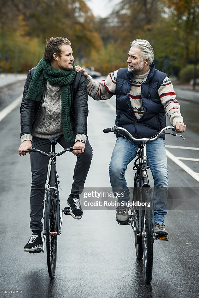 Friends cycling on street