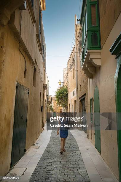 female tourist walking, victoria, gozo, malta - sean malyon stock pictures, royalty-free photos & images